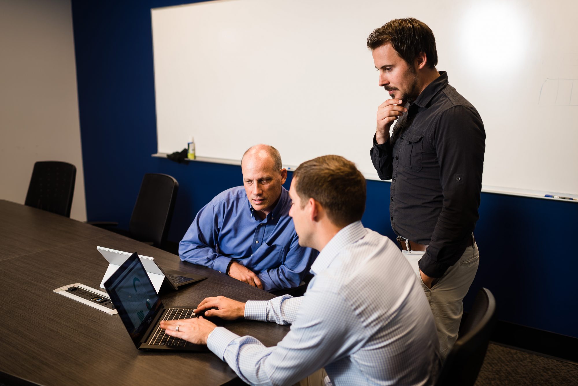 3 men testing ux design changes on a laptop