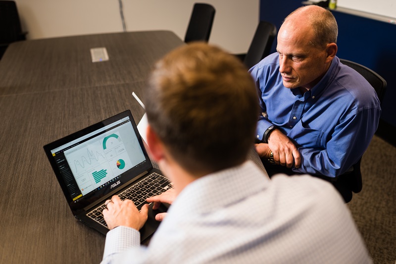 Leadership team reviewing data on computer to ensure accuracy