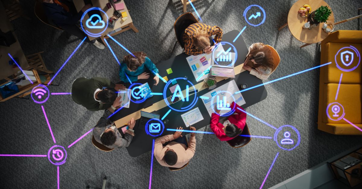 Overhead view of a business team collaborating around a conference table with digital AI icons and analytics dashboards connected across the screen, symbolizing Business Central AI readiness, data integration, cloud security, and real-time performance insights for modern ERP transformation.